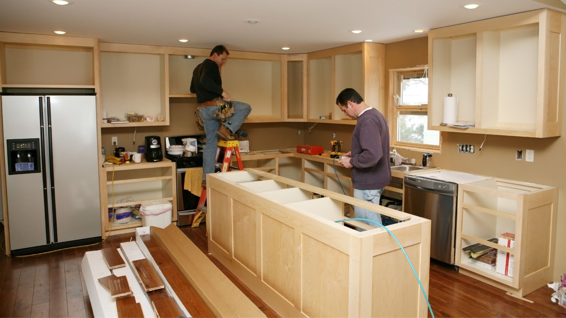 two kitchen contractors building kitchen cabinets